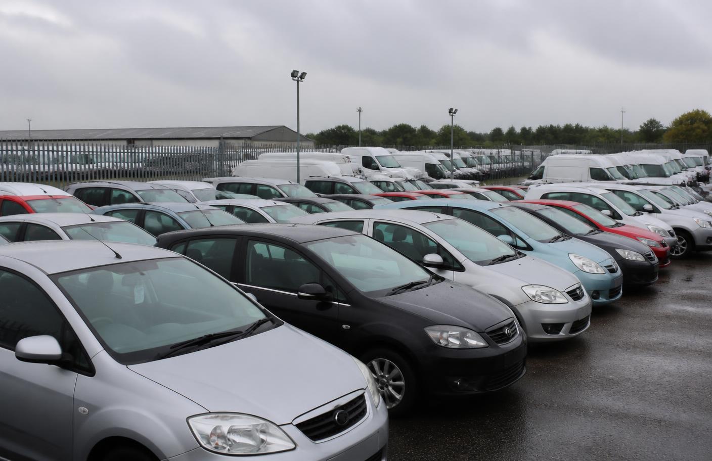 Cars parked in rows at a UK vehicle auction compound